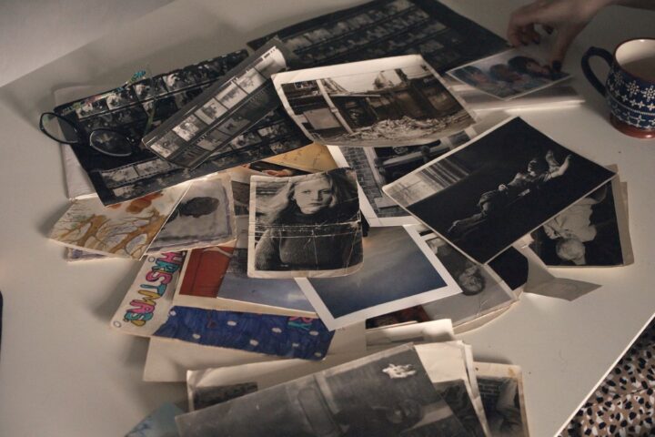 An assortment of photographs are spilled into a pile.
