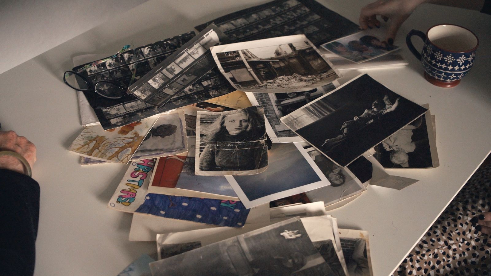 An assortment of photographs are spilled into a pile.