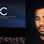 A photo of DOC executive director Julian Carrington placed beside DOC's logo. Carrington is wearing a back shirt, the DOC logo is white letters placed atop a blue background with a crowd seated underneath.
