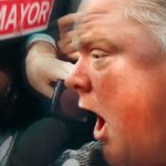A close up image of former Toronto mayor Rob Ford as he yells into a microphone.