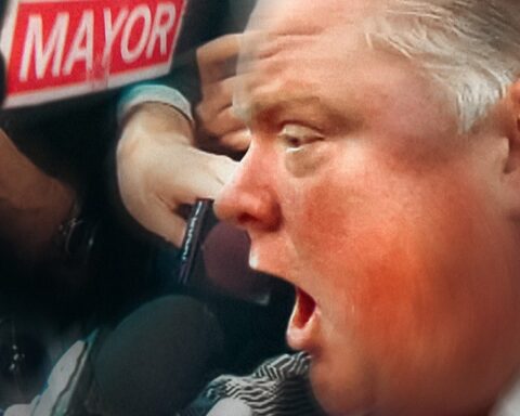 A close up image of former Toronto mayor Rob Ford as he yells into a microphone.
