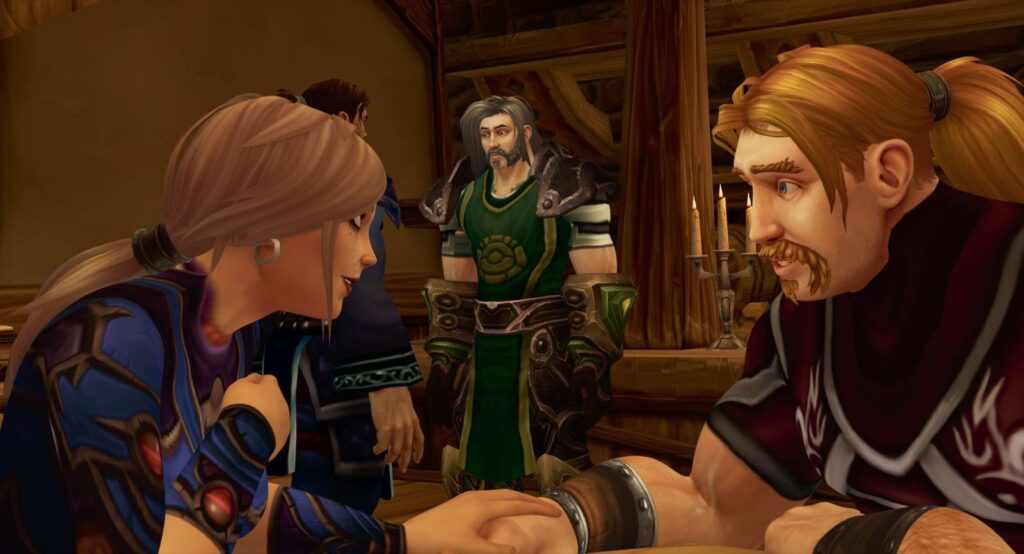 Players in the game World of Warcraft: a woman and a man are seated at a table. They both resemble vikings with long blond hair. The man is talking and gesturing as the woman listens to him.