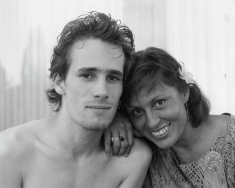 A black and white photo of singer Jeff Buckley and his mother Mary. They have their heads together and are smiling.