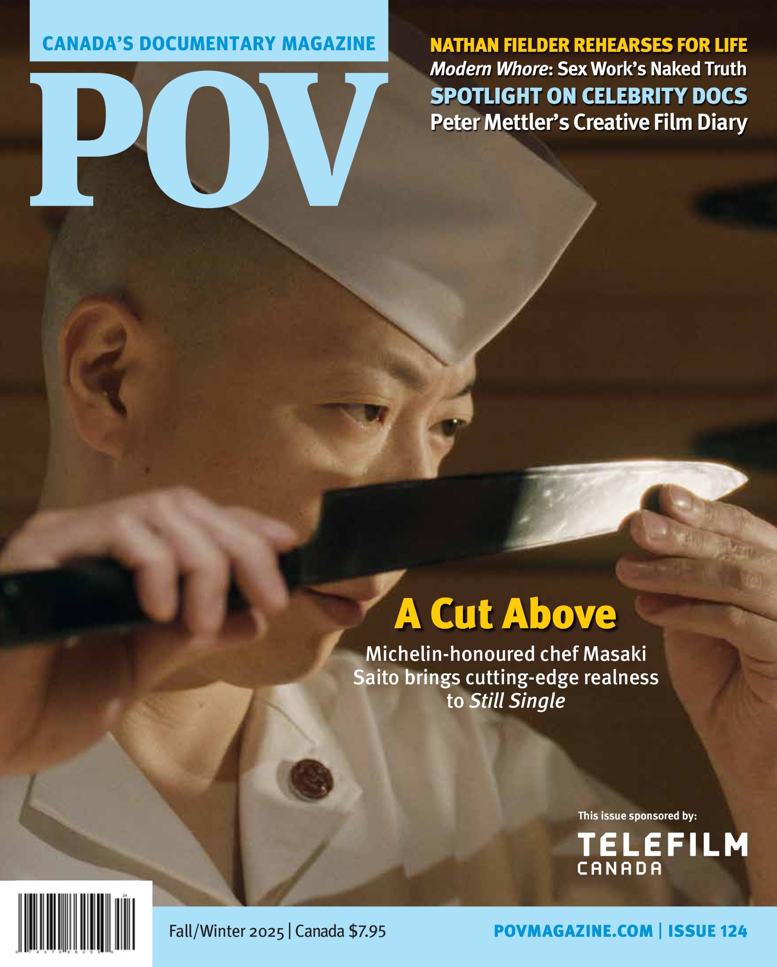 Sushi chef Masaki Saito examines his knife. He is wearing a white hate and looking at the blade intently.