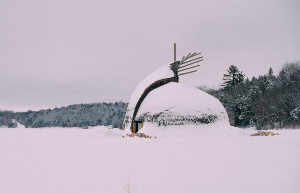 An structure in a Northern Indigenous community sits amid a snowy landscape.