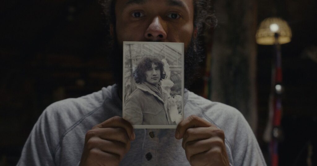 Tyler Cameron holds a black and white photograph of his father, Ojibway Warrior Louie Cameron.