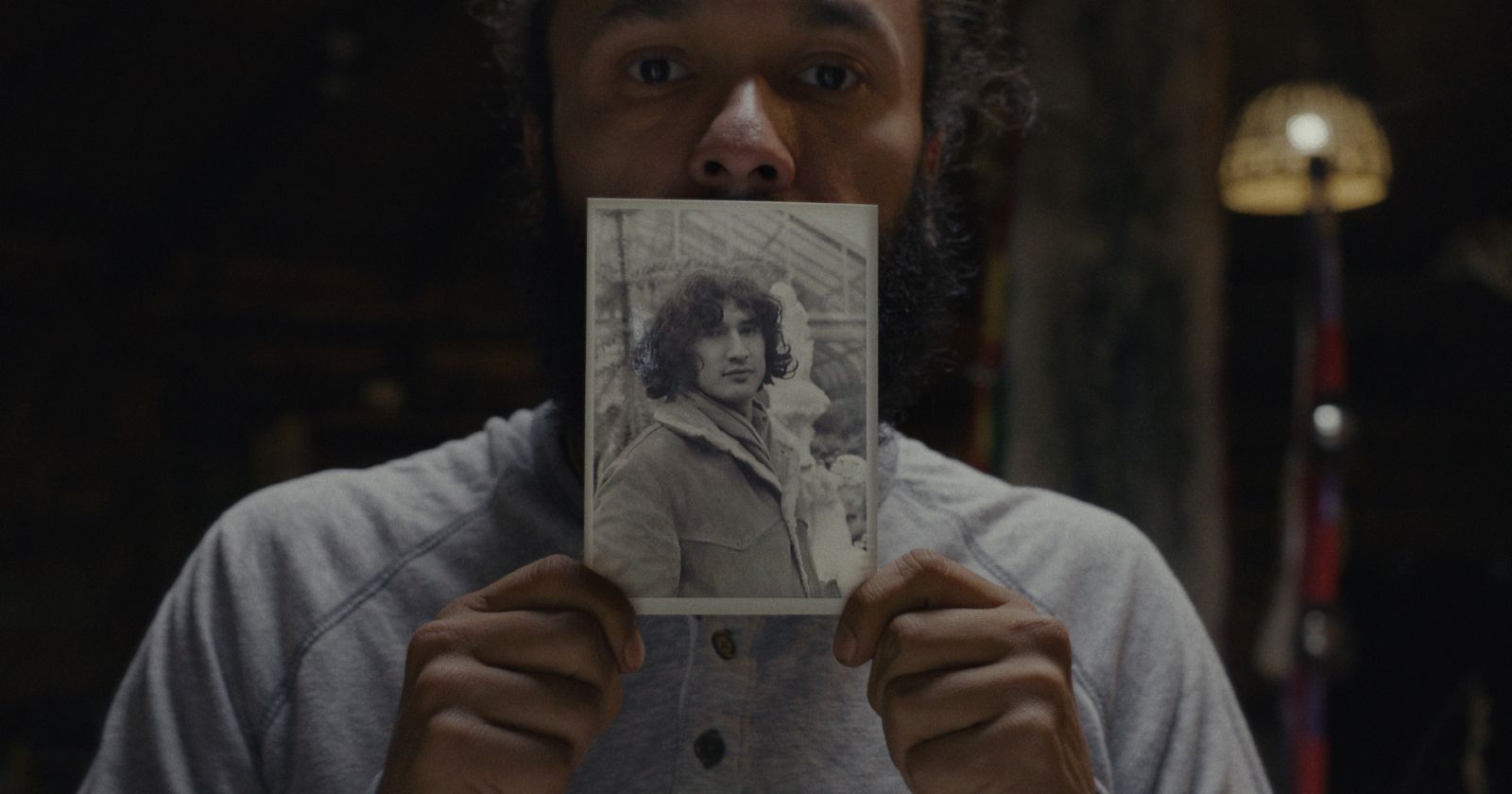 Tyler Cameron holds a black and white photograph of his father, Ojibway Warrior Louie Cameron.