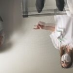 A point of view shot from a patient in a hospital bed, looking at two blurry doctors who are upside down.