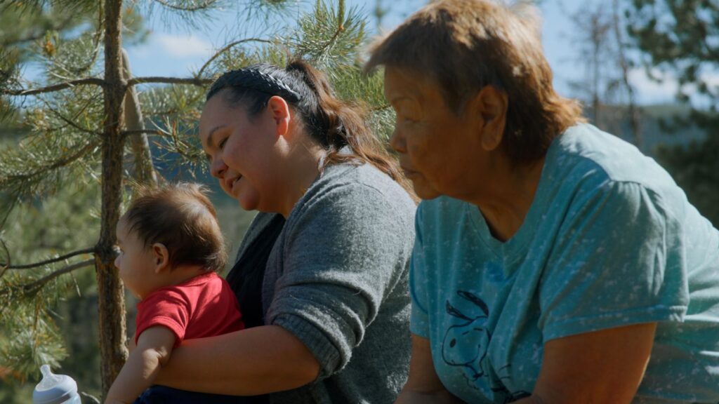 Saik’uz Elder Minnie Thomas, Saik’uz First Nation Councillor Jasmine Thomas and baby. Image courtesy of the National Film Board of Canada, Lantern Films, and Experimental Forest Films.