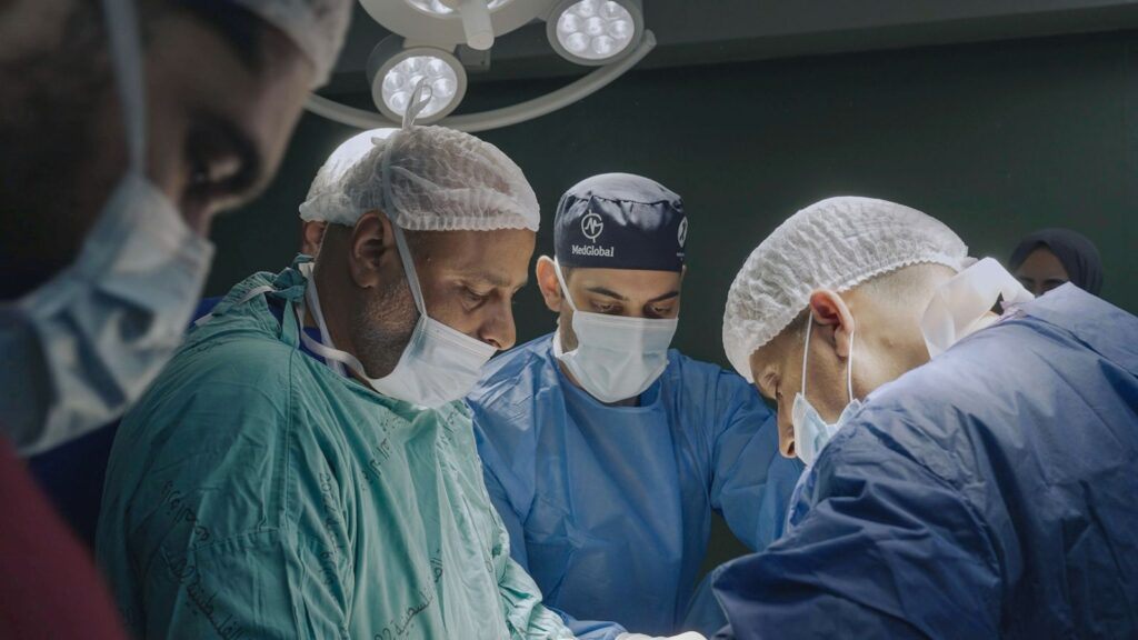A team of doctors in an operating room.