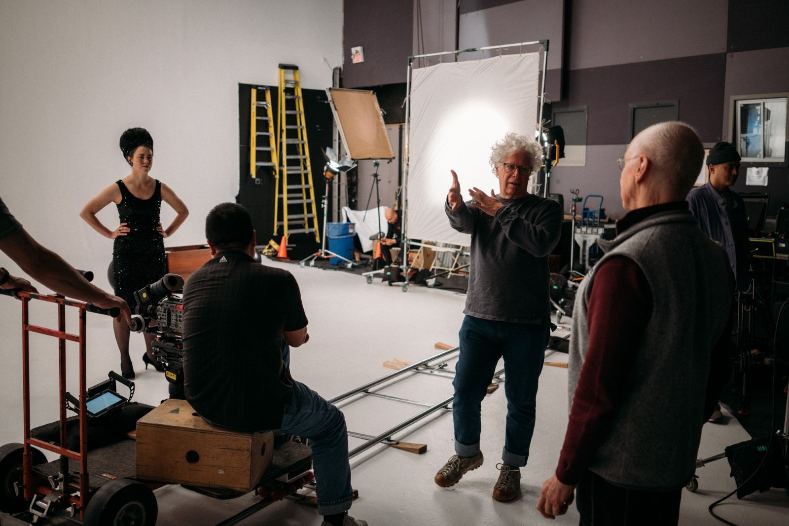 Filmmaker Ron Mann directors a documentary film crew on a sound stage.