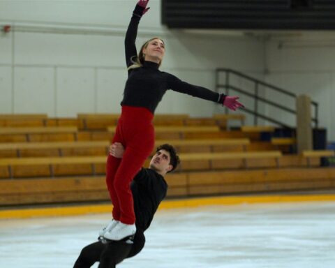 Ice dancers Piper Gilles and Paul Poirier do a lift while training.
