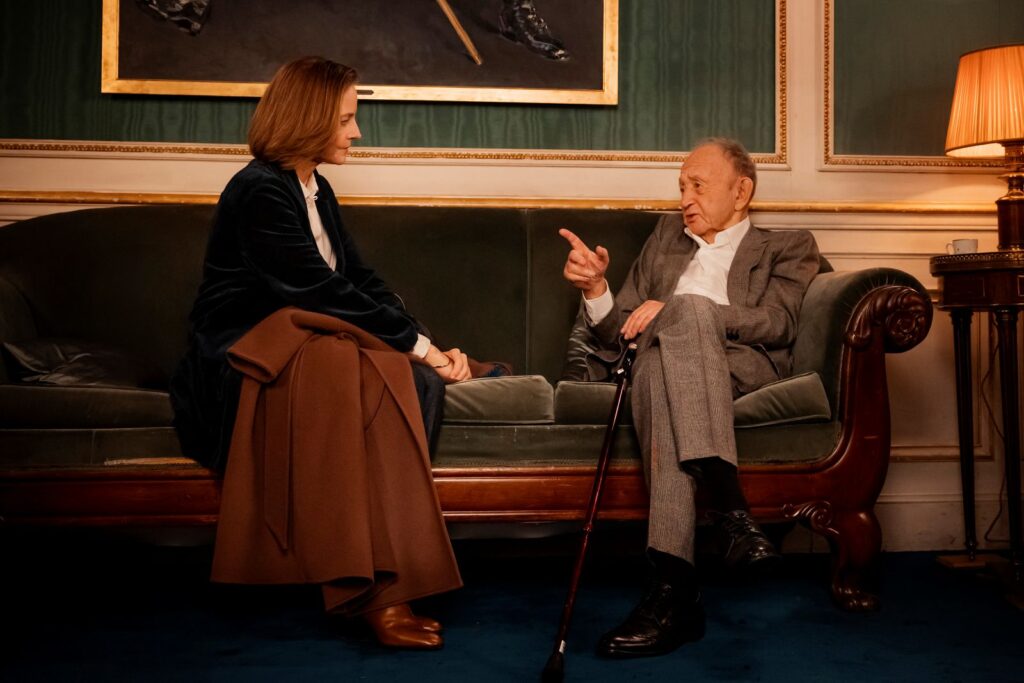 96 year old filmmaker Frederick Wiseman and actress Jodie Foster sit facing each other on a couch.