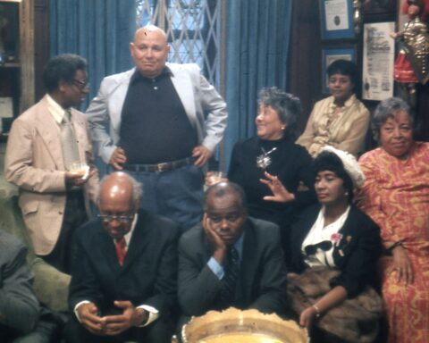 Sitting (left to right): Thomas Harvey, William Patterson, John Henrik Clarke, Mrs. J.B Matthews, Louise Patterson. Standing (left to right): Ernest Chrichlow, Romare Bearden, Ida Mae Cullen. Photo taken in 1972. Credit: Bruce Stanford. Courtesy: William Greaves Productions