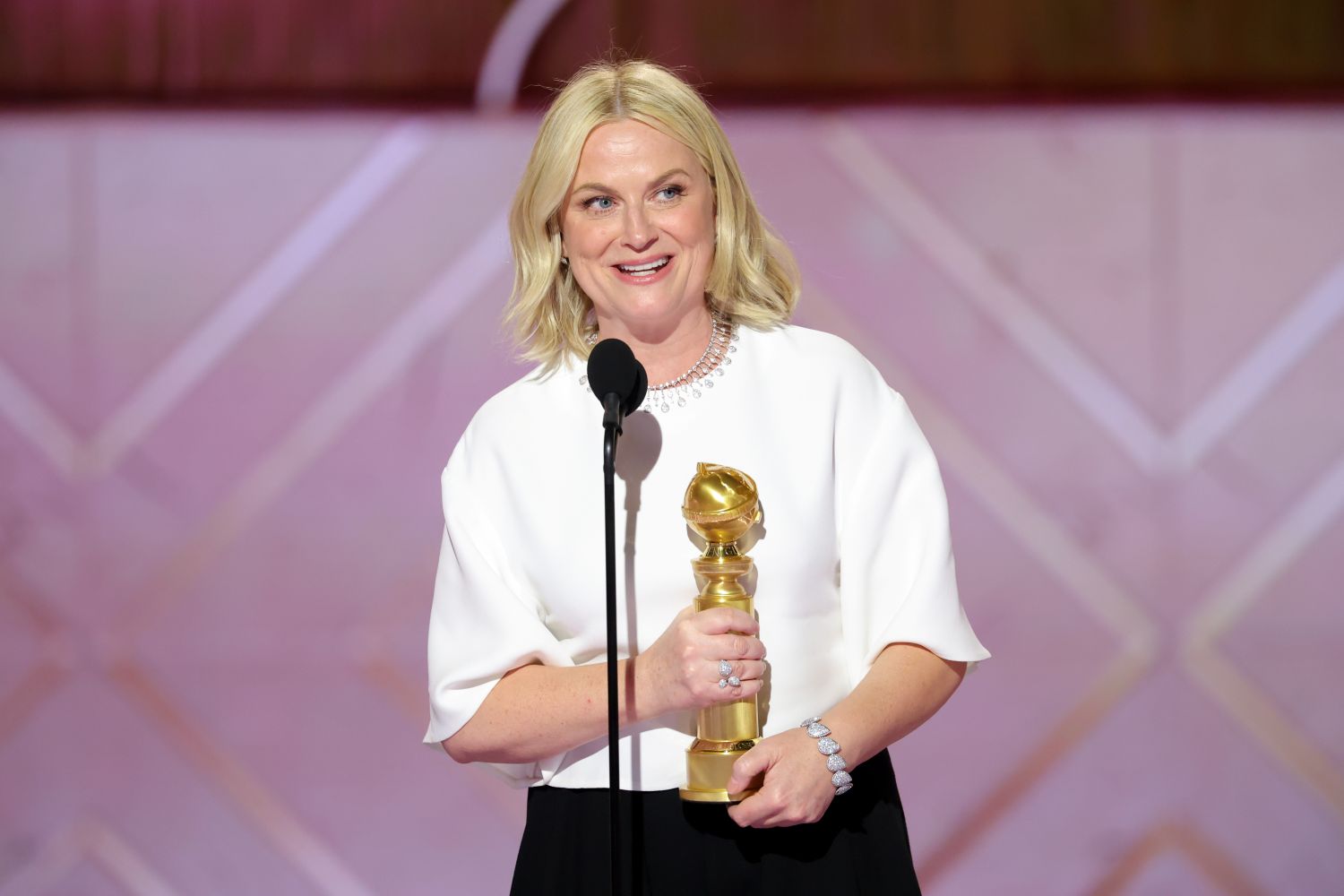 Amy Poehler accepts the Golden Globe for Best Podcast.