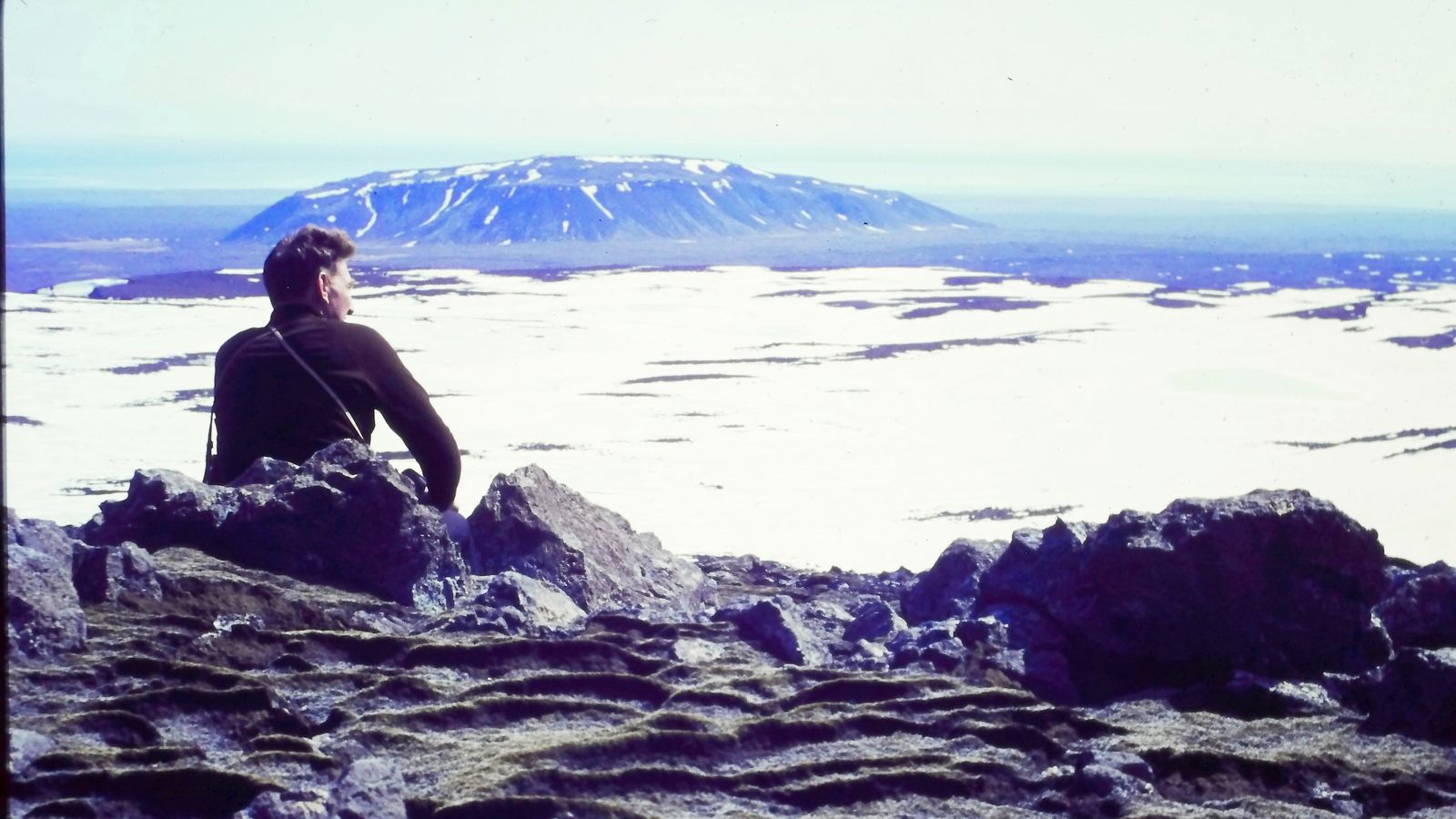 Árni Kjartansson sits overlooking a glacier in Iceland. | Courtesy of Andri Snær Magnason