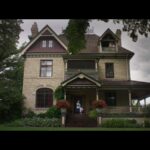 A photograph of a Victorian mansion on a cloudy day.