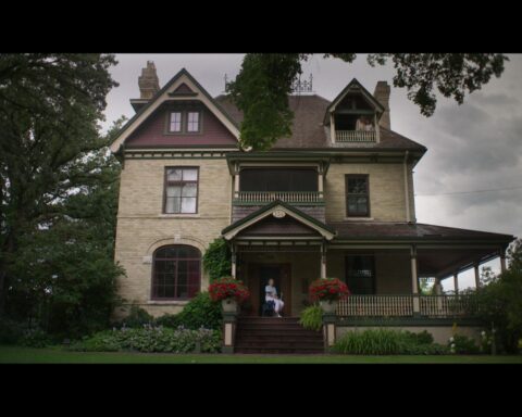 A photograph of a Victorian mansion on a cloudy day.