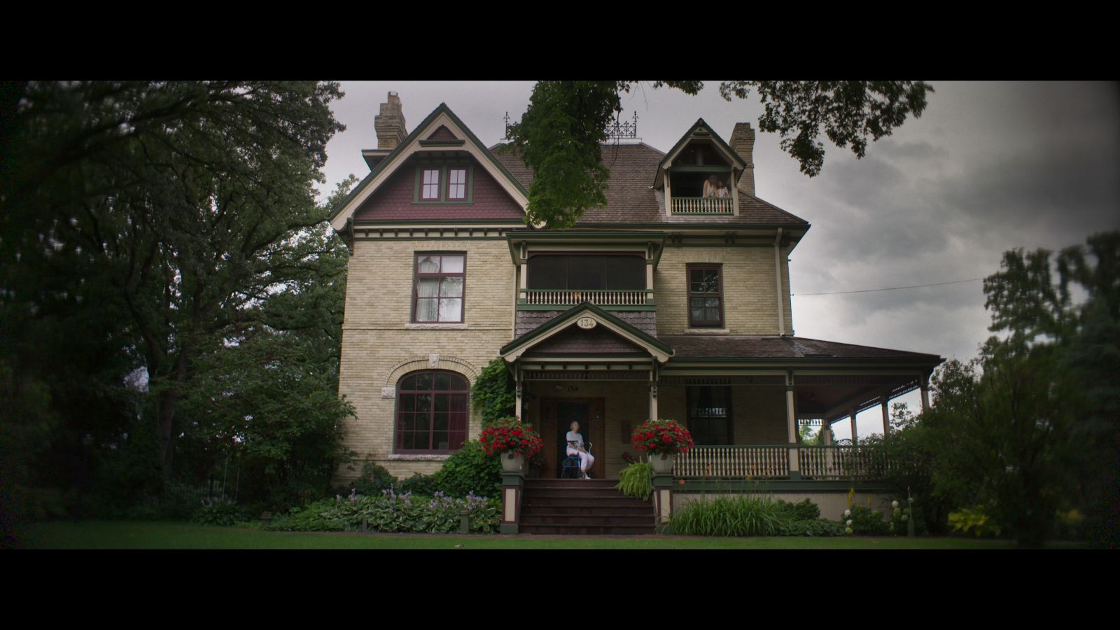 A photograph of a Victorian mansion on a cloudy day.