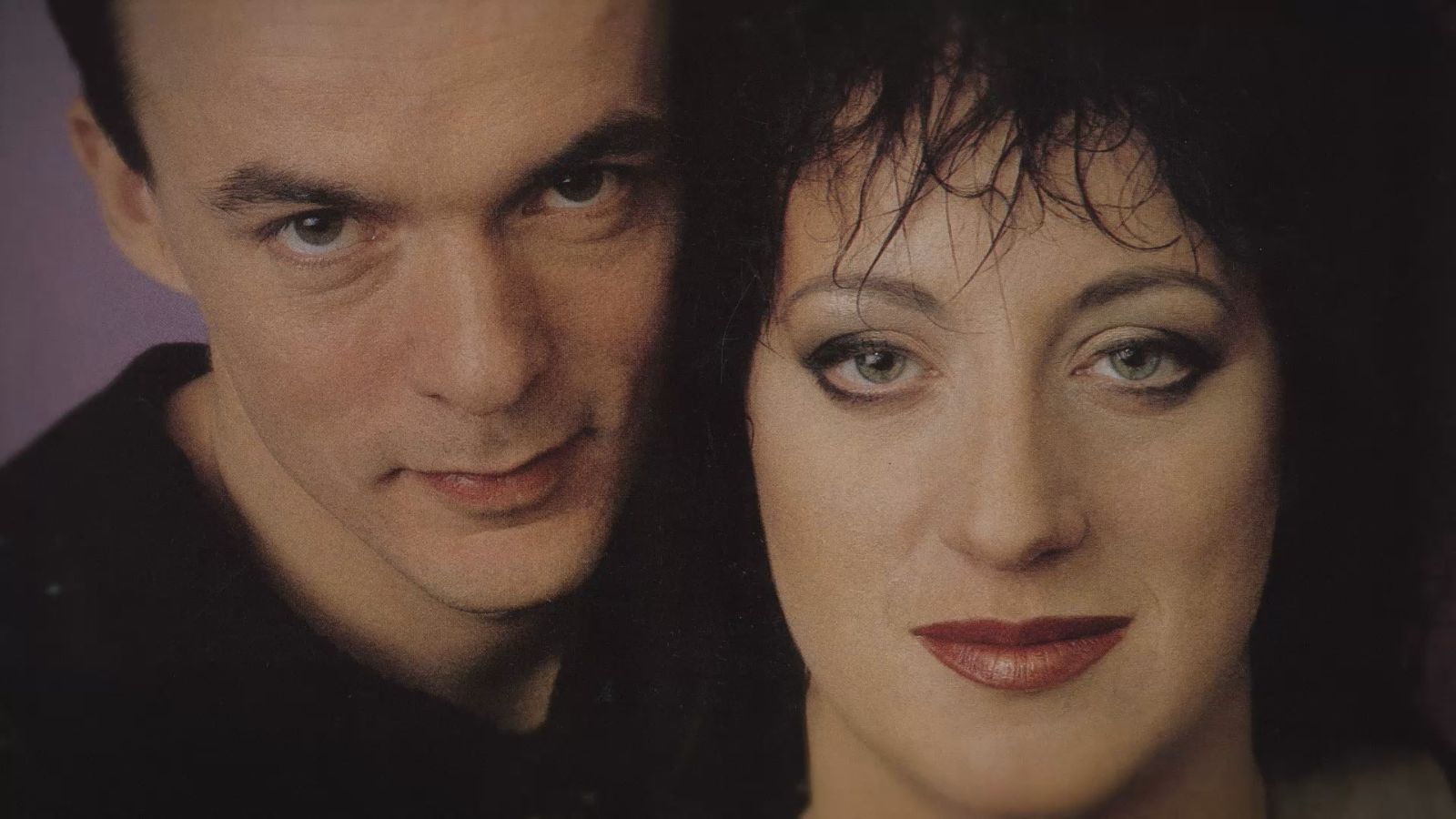 An archival image of Rough Trade musicians Carole Pope and Kevan Staples. They are pictured in close-up with their faces side by side.