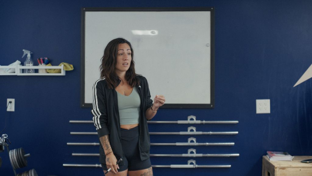 Catherine Laroche leads a workshop for young hockey players on self-esteem, performance anxiety, and harmful behaviours, drawing on her own experience as a survivor to promote healthier team environments.