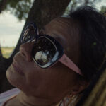 Lydia rests in a hammock, reflecting during a rare moment of stillness in the heat of the day.