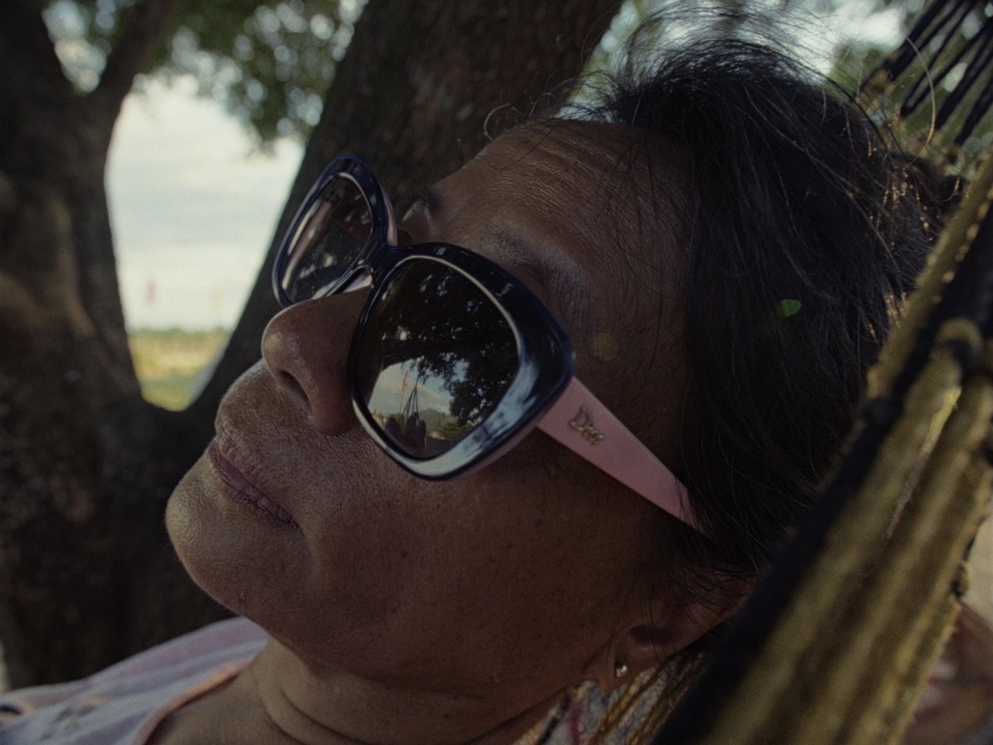 Lydia rests in a hammock, reflecting during a rare moment of stillness in the heat of the day.