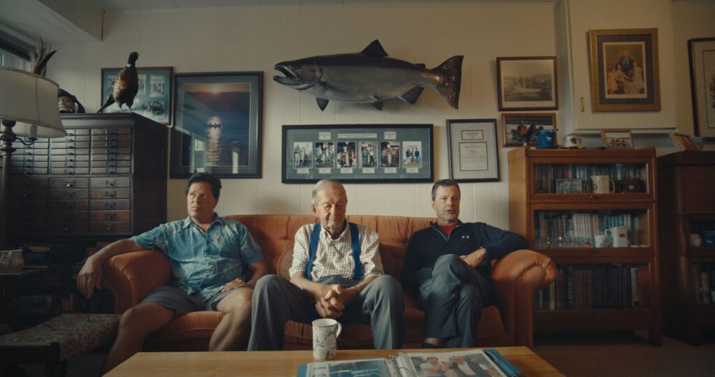 Richard, Mike, and Roger Gage at the Gage family home. Mike’s 61.5-pound Tyee hangs on the wall above them