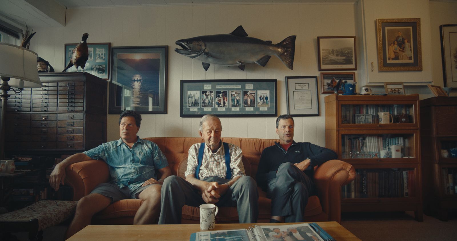 Richard, Mike, and Roger Gage at the Gage family home. Mike’s 61.5-pound Tyee hangs on the wall above them