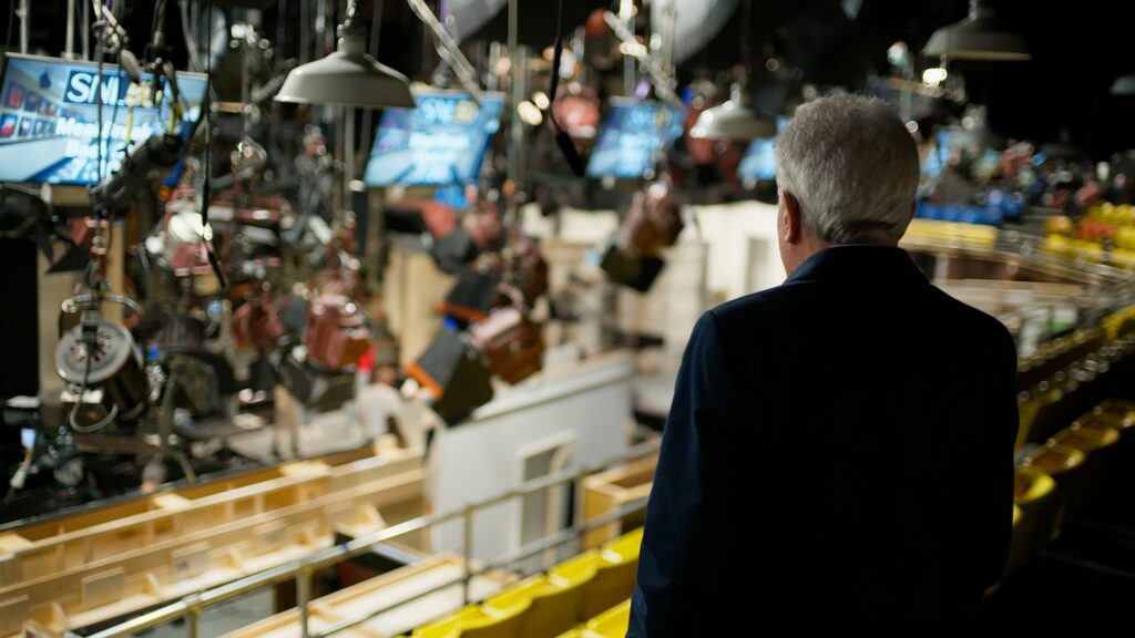 A view from behind producer Lorne Michaels as he looks out at the set of Saturday Night Live.