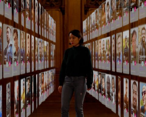 A woman stands surrounded by images of dating app profiles of various men. She looks overwhelmed.