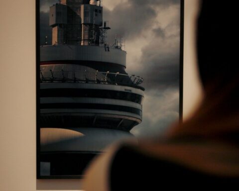- Caitlin Cronenberg (foreground), looking at her photo of Drake’s Views album cover, hanging in the AGO.