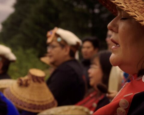 Nuskmata sings during a ceremony at the sputc pole on the bank of the Bella Coola River, honouring the fish and the enduring relationship between people and place.