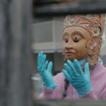 Deneth Piumakshi Veda Arachchige with an indigenous mask from the Museum of Cultures, Basel (CH)