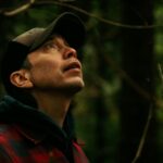 Qwaxw visits the gravesite at Nusq’lst Village, confronting the legacy of smallpox and dispossession that reshaped Nuxalkulmc (Nuxalk Territory).
