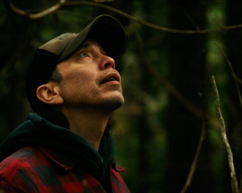 Qwaxw visits the gravesite at Nusq’lst Village, confronting the legacy of smallpox and dispossession that reshaped Nuxalkulmc (Nuxalk Territory).
