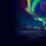 A nighttime image shows the northern lights with ripple through the sky like a Pride flag
