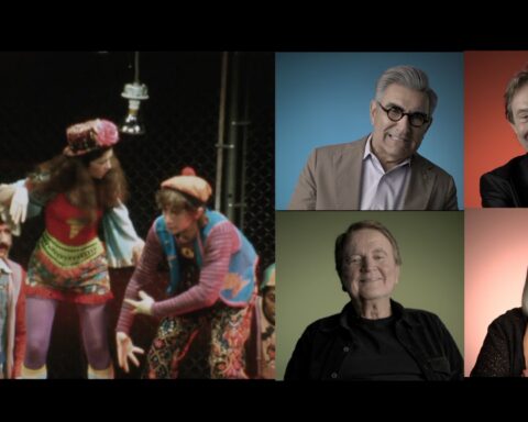 A splitscreen image shows an archival image of a 1970s stage production on the left. There are actors crouched together wearing colourful hippie costumes. On the right side, the screen is split into quadrants with four actors giving interviews with a different coloured background, going clockwise as red, yellow, green, and blue.