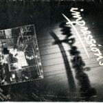A cover of an old magazine displays a black and white image with the title 'Impressions' written in white text with a line underneath.
