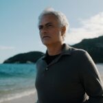 José Mourinho stands on a beach.