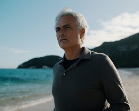 José Mourinho stands on a beach.