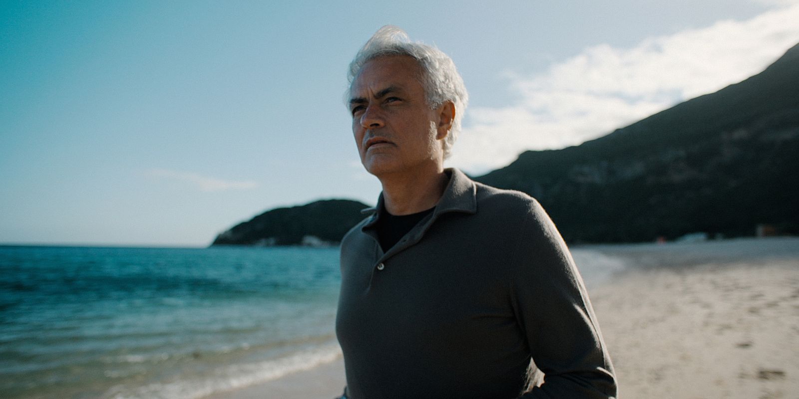 José Mourinho stands on a beach.