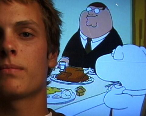 The face of a white man with an early 2000s' hairstyle is pictured beside a fuzzy TV screen showing a scene from Family Guy, where an overweight man in a suit sits at a table with a white dog.