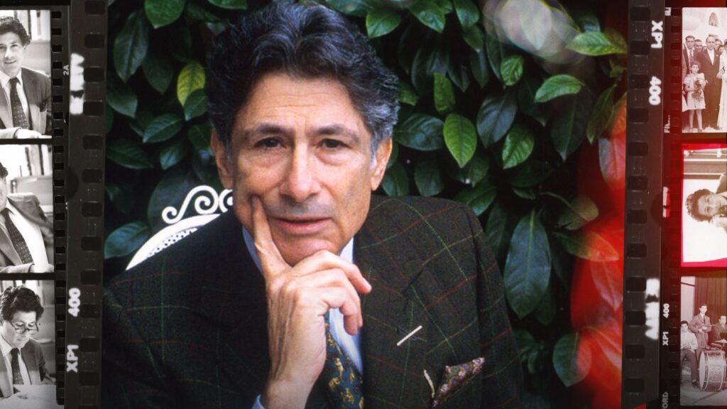 Academic Edward Said looks directly into the camera, posing with this chin on his hand to express thought. He is wearing a suit and there are green leaves behind him. The portrait is bordered by strips of black and white photographs.