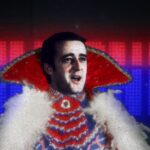 Prime Minister Brian Mulroney appears in a flamboyant Liberace-style outfit with a high collar and white furry trim. The name Mulroney appears behind him in red and blue lights.