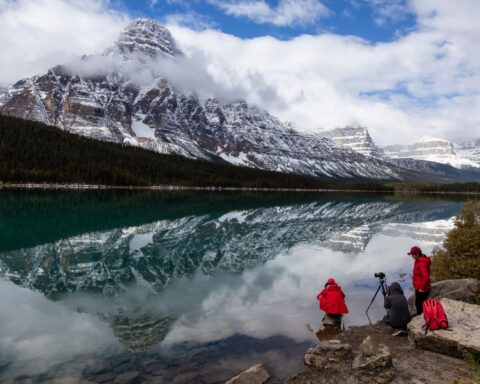 Icefields Pkwy, Banff National Park, Alberta, Canada - September 24, 2018: Photographers taking pictures of Beautiful Canadian Rockies Landscape during a cloudy day.